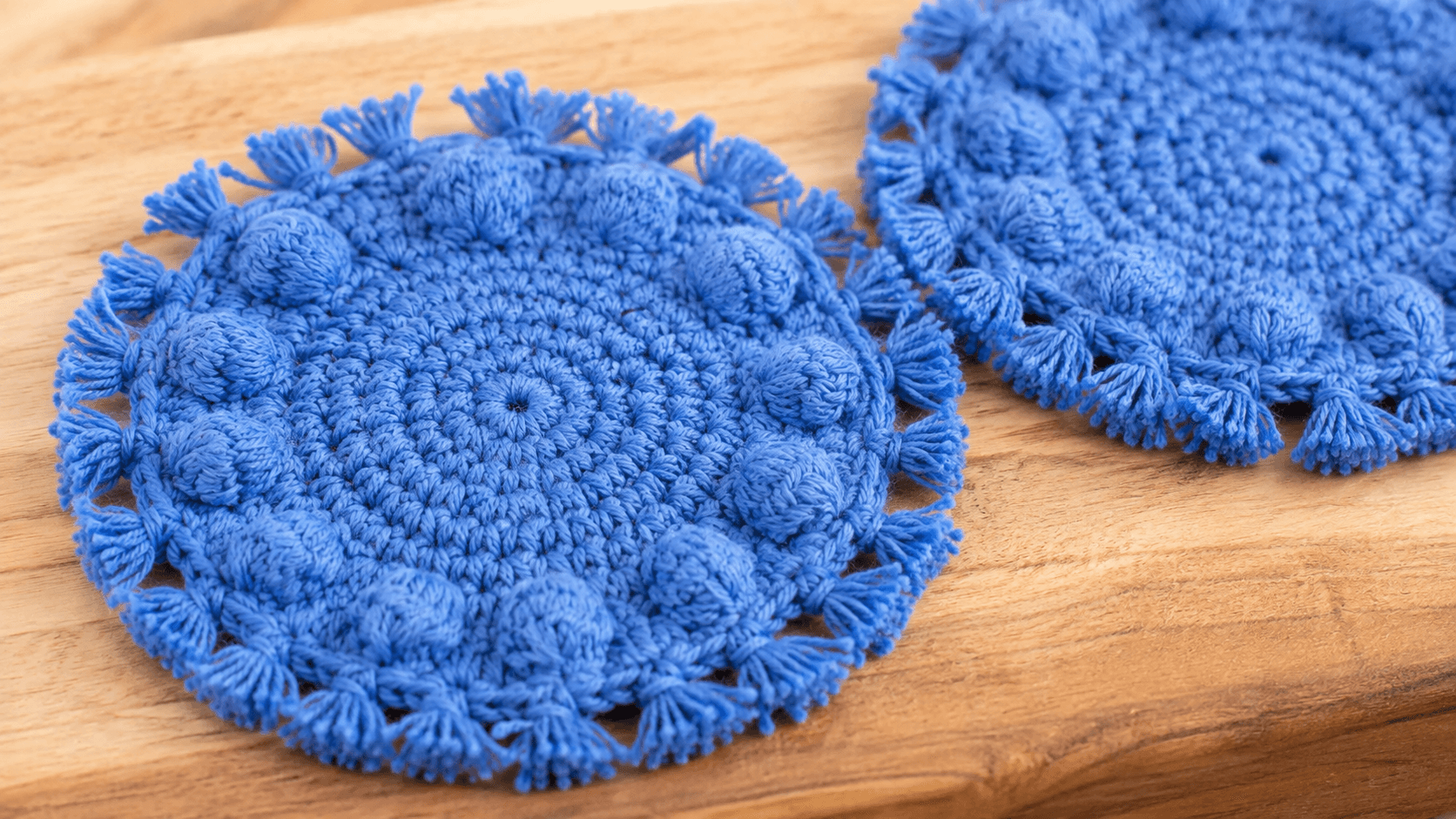 Blue crochet coasters with bobble texture and fringe