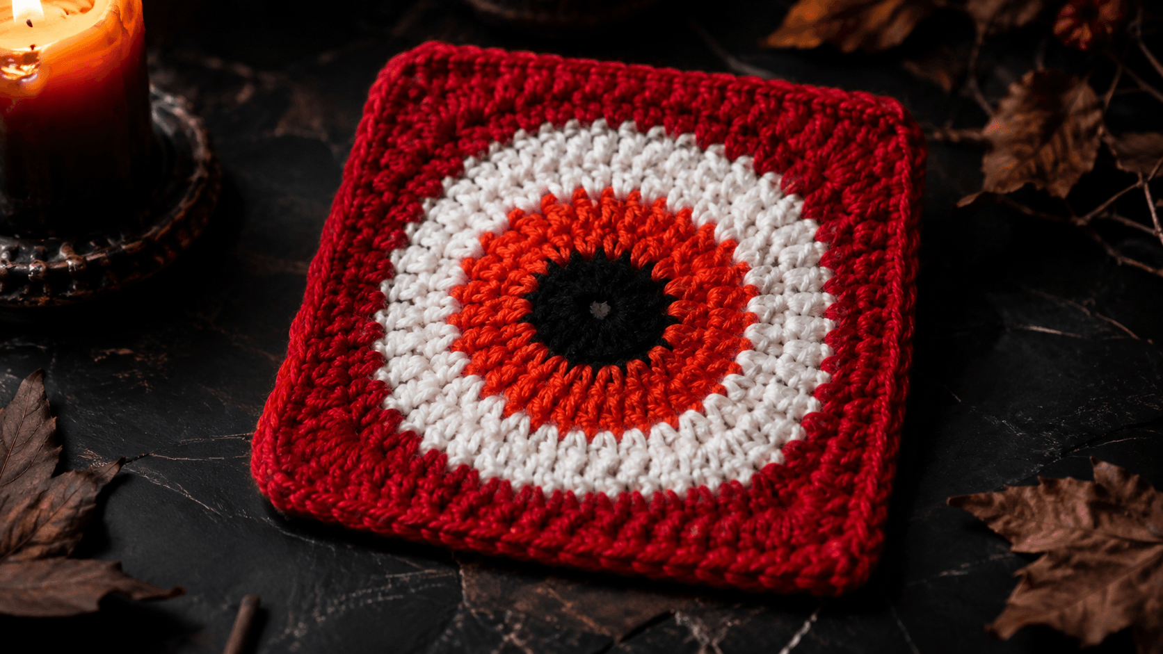 Devil Eye Granny Square - hero shot: A finished solid (no-gap) granny square in concentric-ring eye design: black pupil