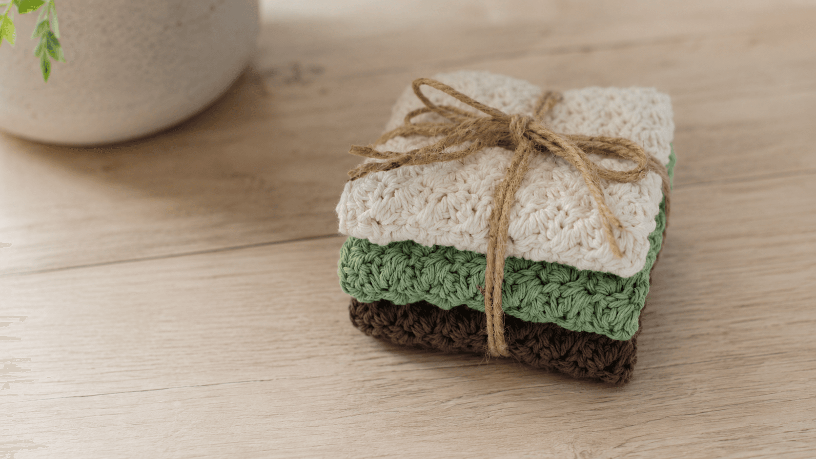 Stack of three crochet dishcloths tied with twine
