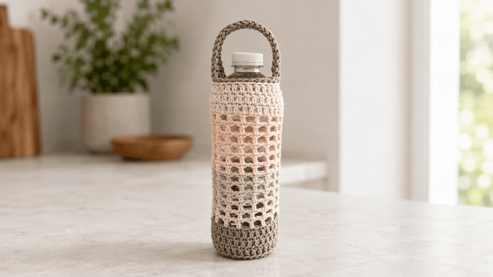 Cream, pink, and gold openwork crochet water bottle holder