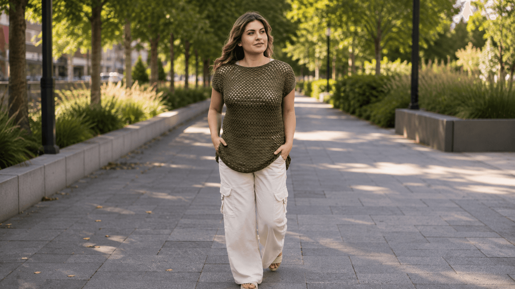 Woman wearing an olive green open mesh crochet top outdoors