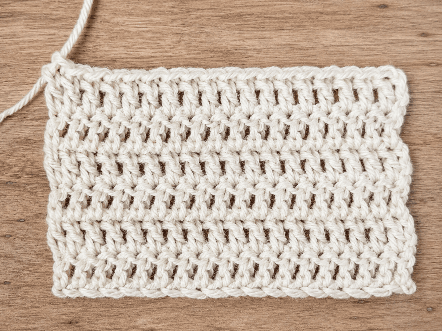 How to Double Crochet (tutorial) - detail shot: A flat swatch of double crochet fabric rows
