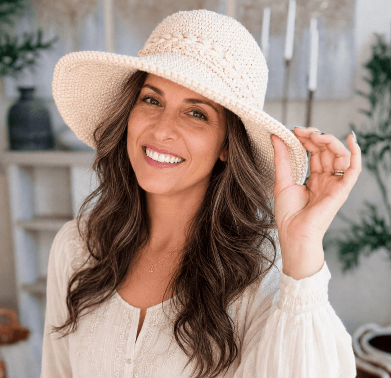 Hachim, founder of KnotToYarn, wearing one of her own crochet sun hat patterns