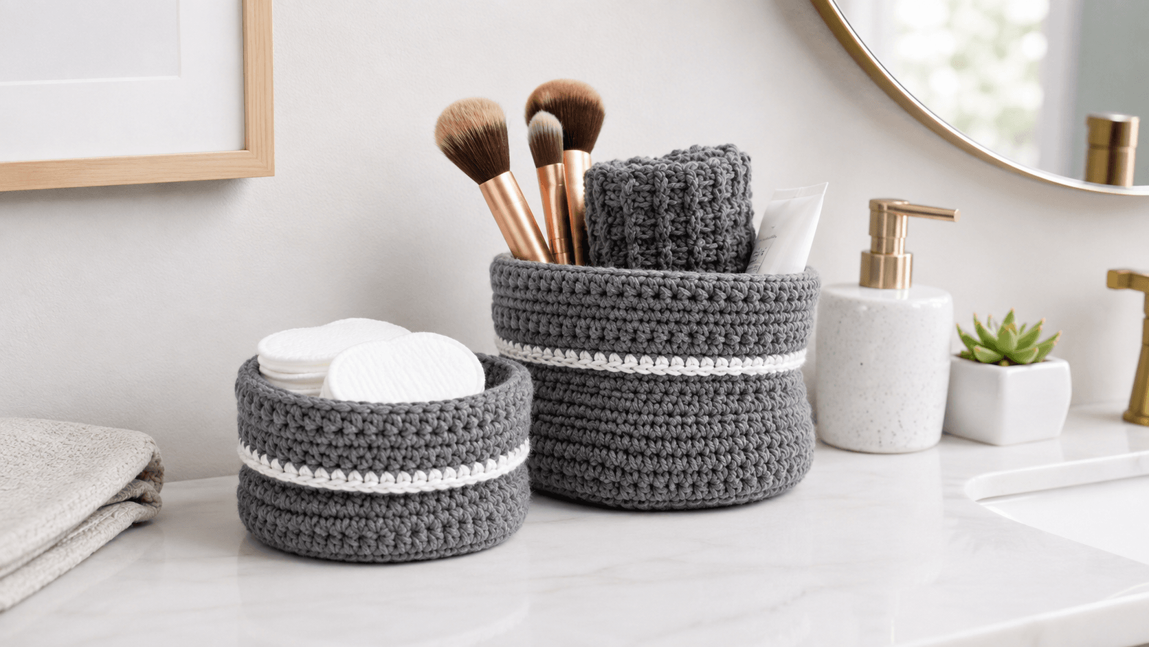 Two gray and white crochet nesting baskets in a bathroom