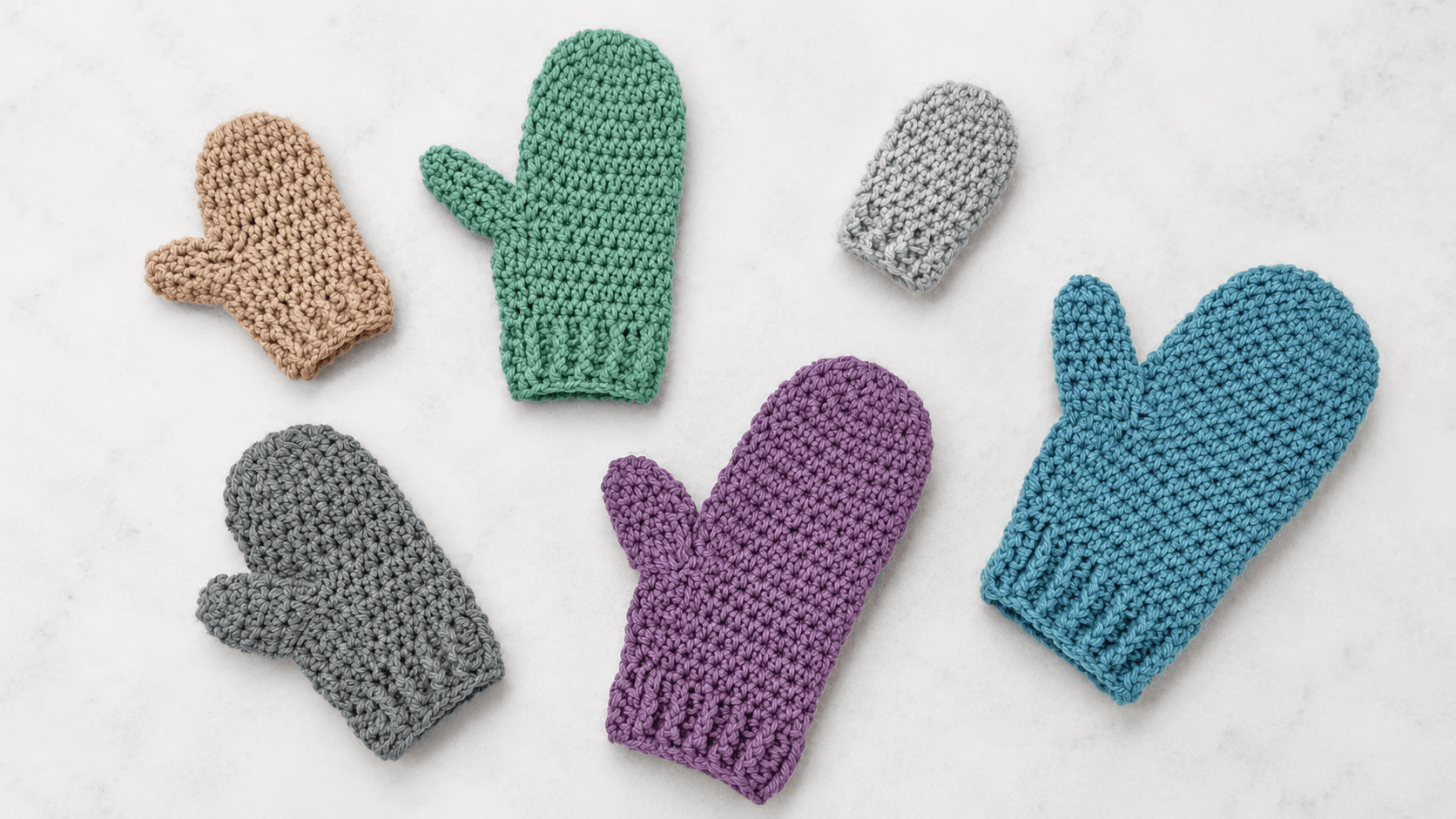 Six colorful crochet mittens in different sizes