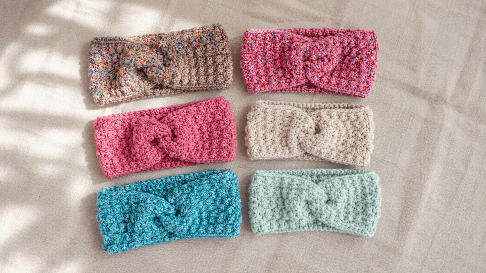 Six twisted-knot crochet ear warmer headbands in various colors