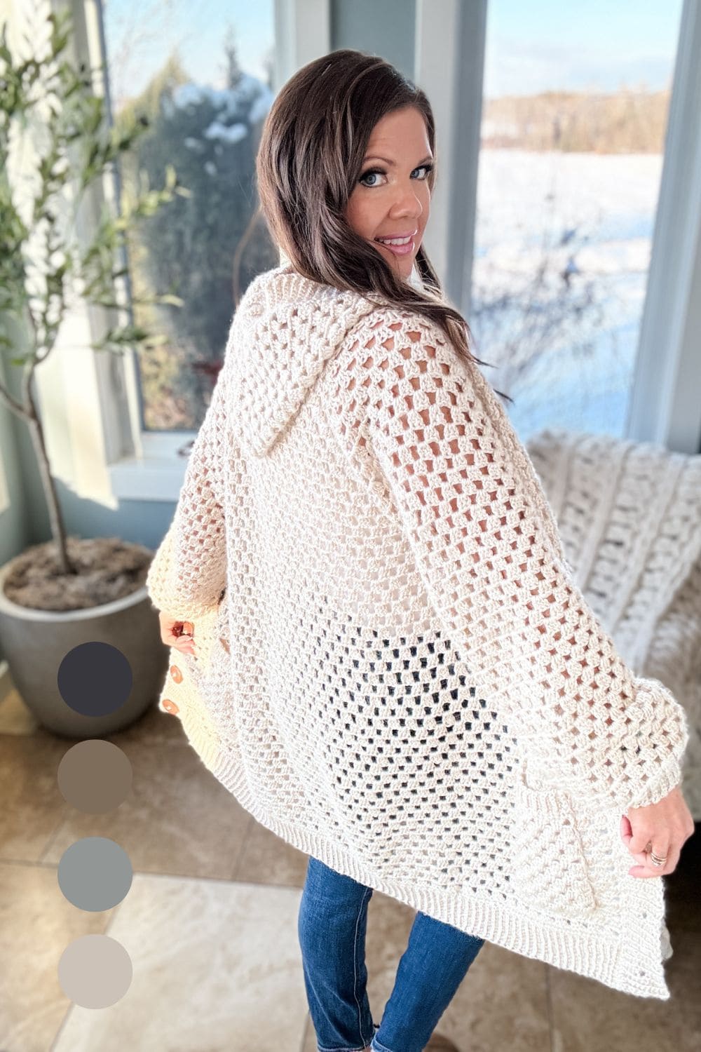 Cream granny stitch hooded crochet cardigan worn open over jeans
